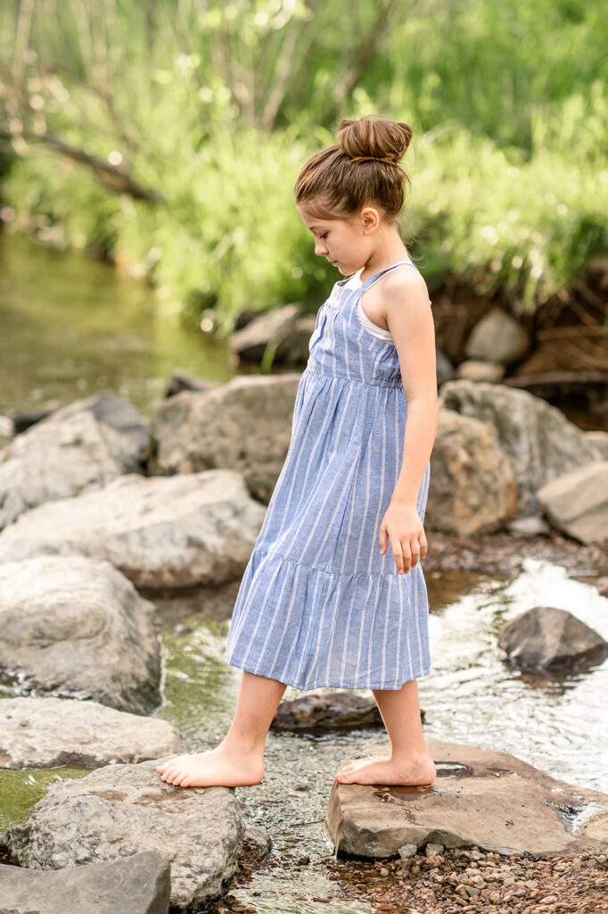 Little girl walking on rocks in creek during family session in York PA