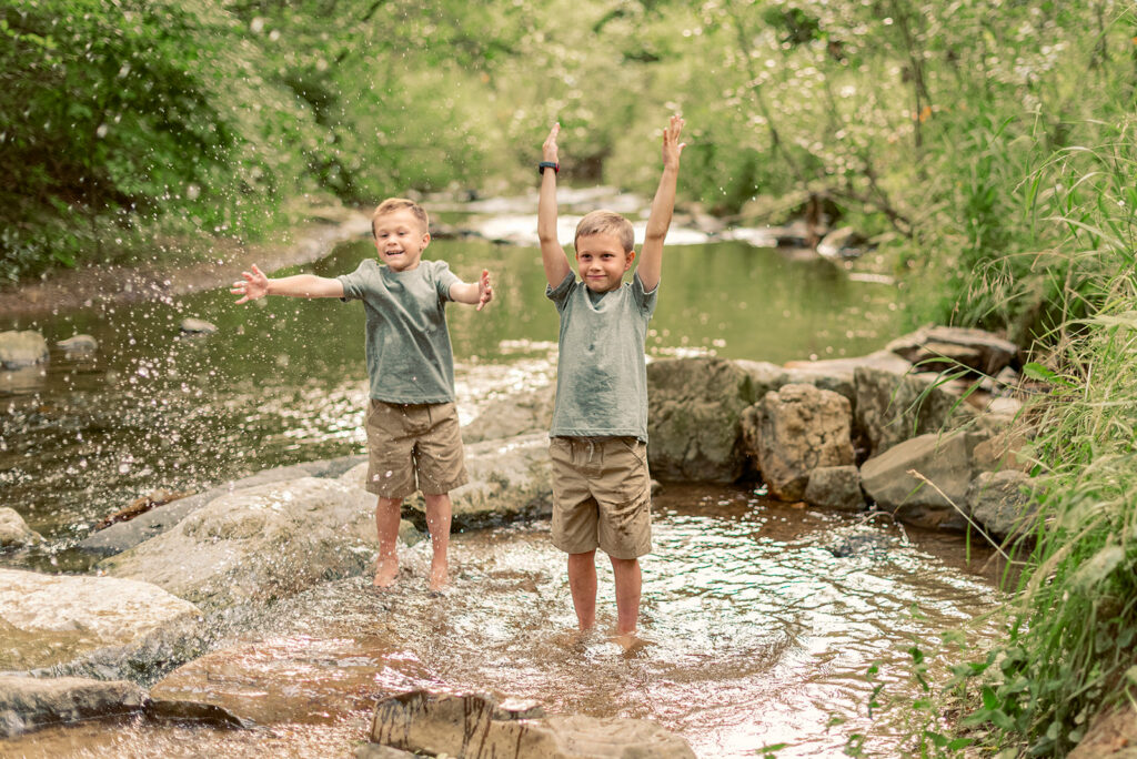 Children splashing in creek during family photo session at Mill Creek Preserve in York PA
