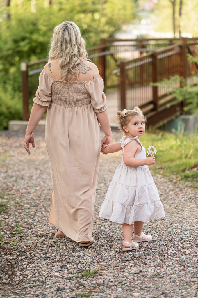 Mother and daughter walking together on path in York PA during family session