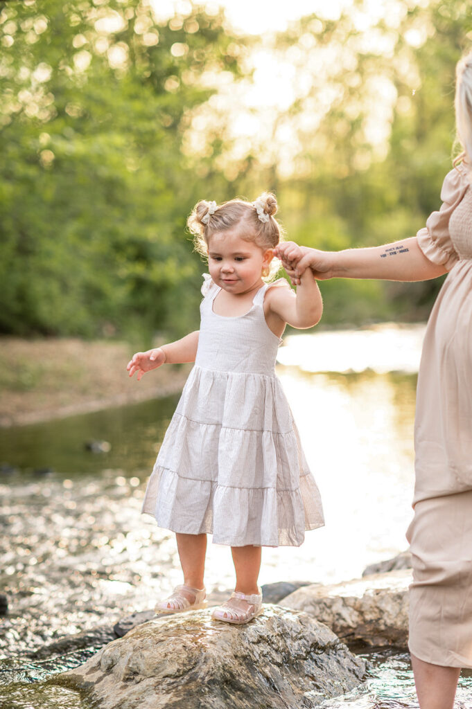 Toddler standing on rock in creek during family session in York PA