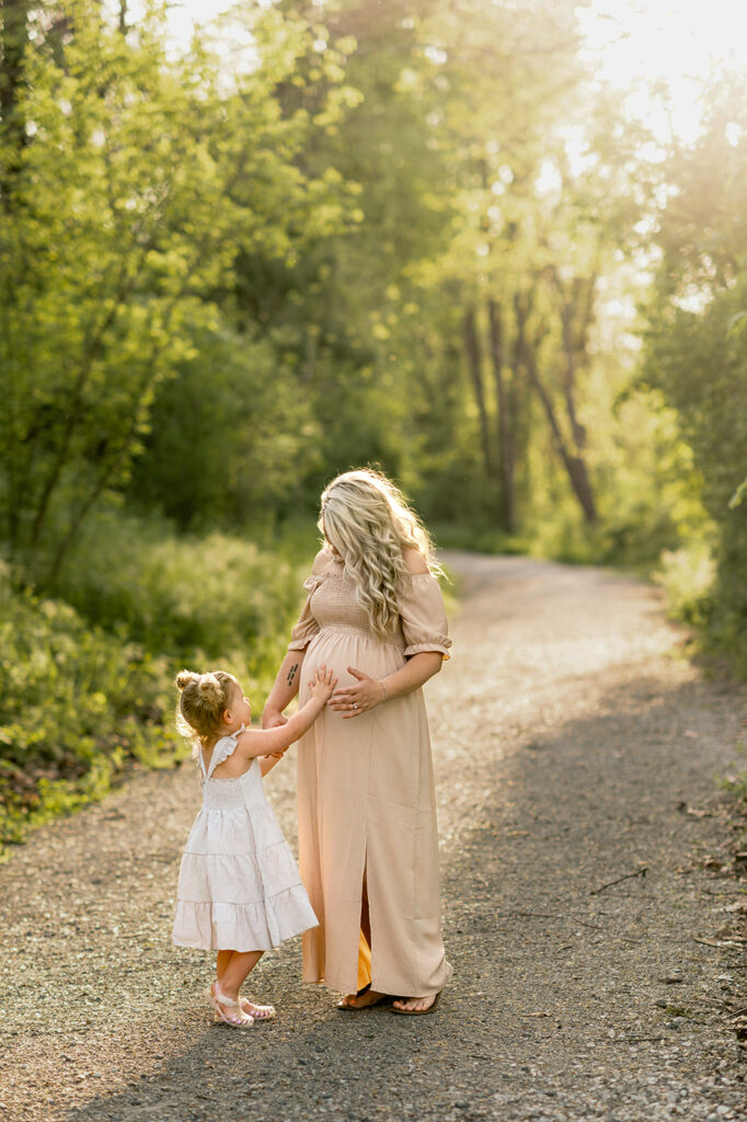 Toddler touching pregnant mother’s belly during maternity session in York PA