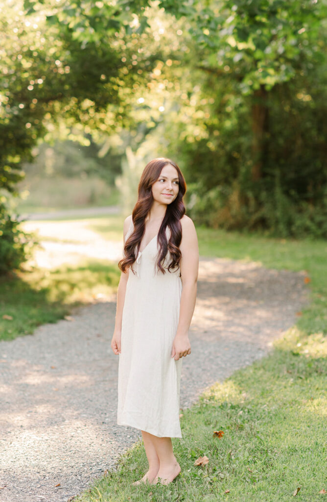 Senior portrait session at Mill Creek Preserve in York PA with girl standing on wooded trail