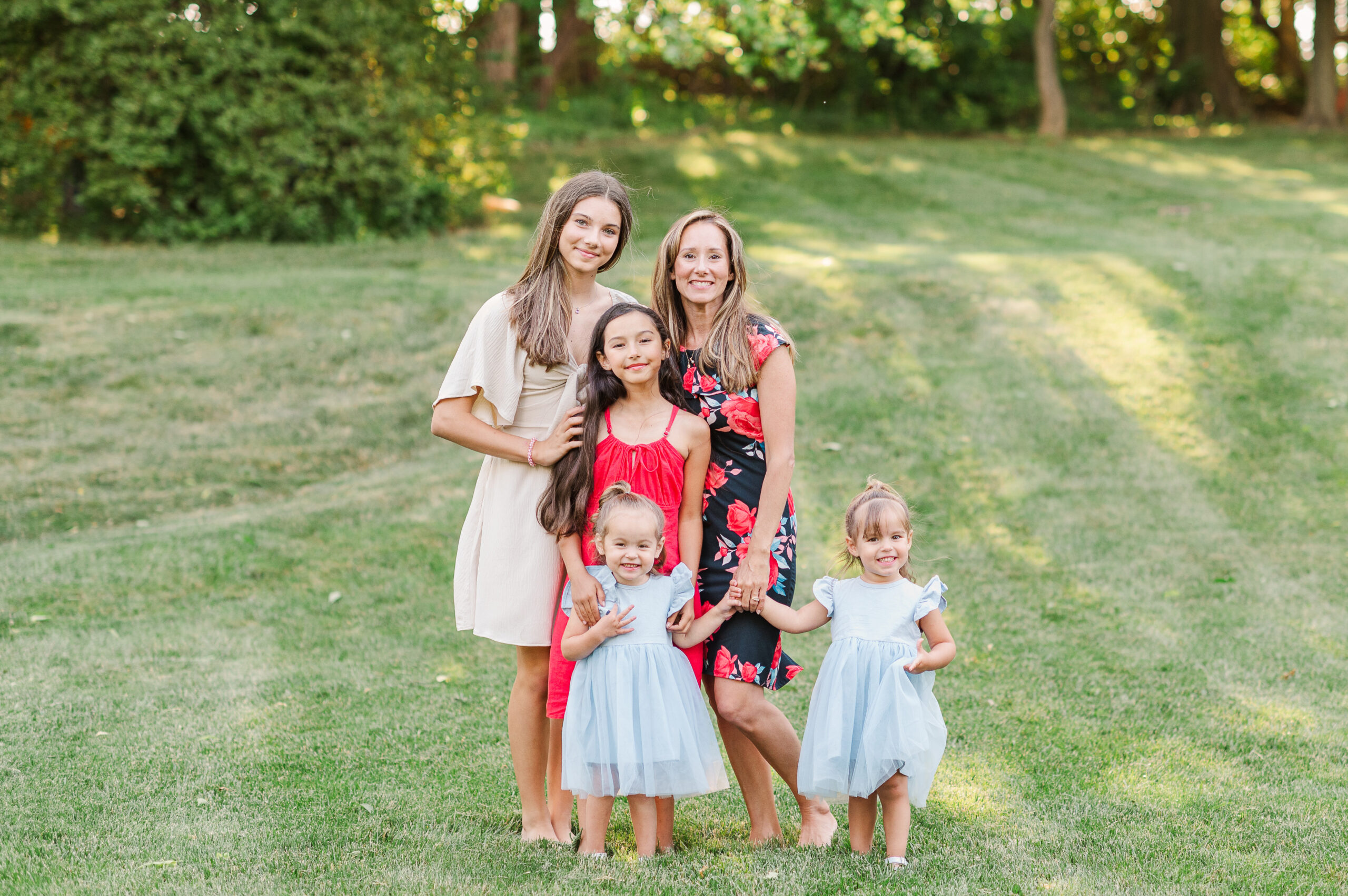 Mother posing with four daughters during golden hour session at home by photographer york harrisburg lancaster pa