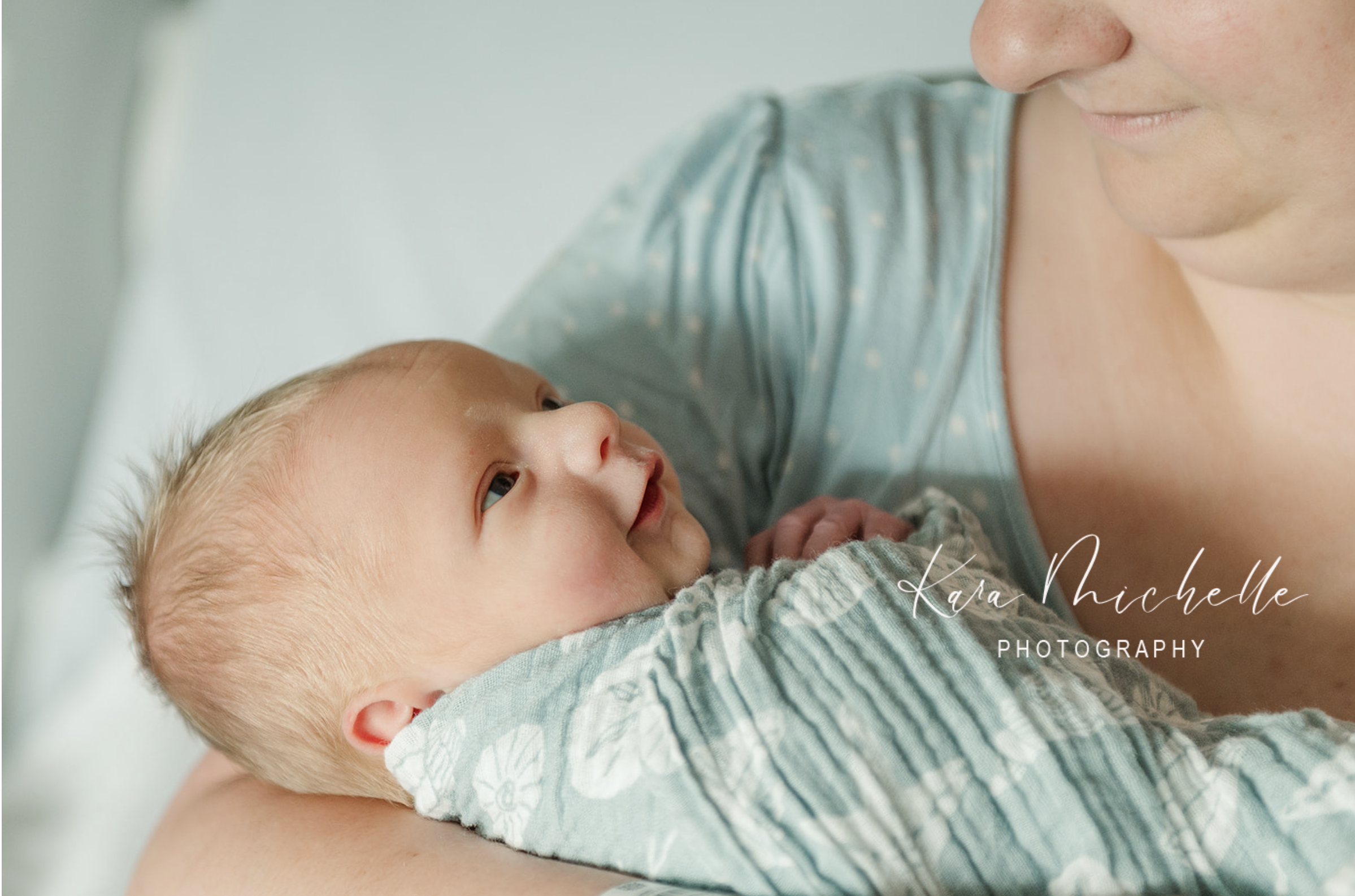 Mother looking at baby by newborn photographer york pa