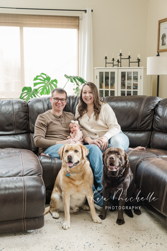 family posing with pets at home by newborn photographer york pa