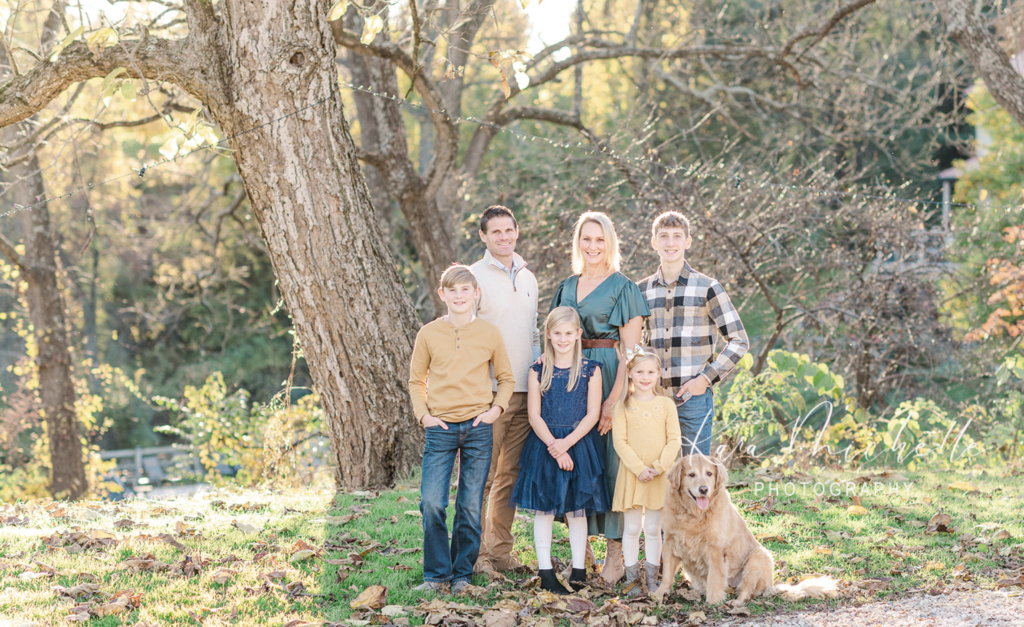 family posing with their dog at home by photographer york pa