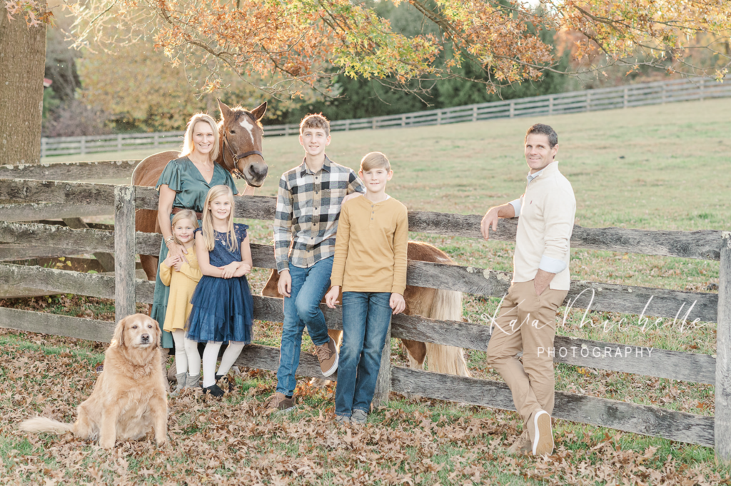 Family posing with their horses and dog by photographer york pa