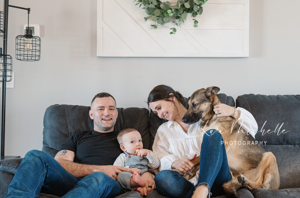 Family posing during in home lifestyle session with their dog by photographer york pa