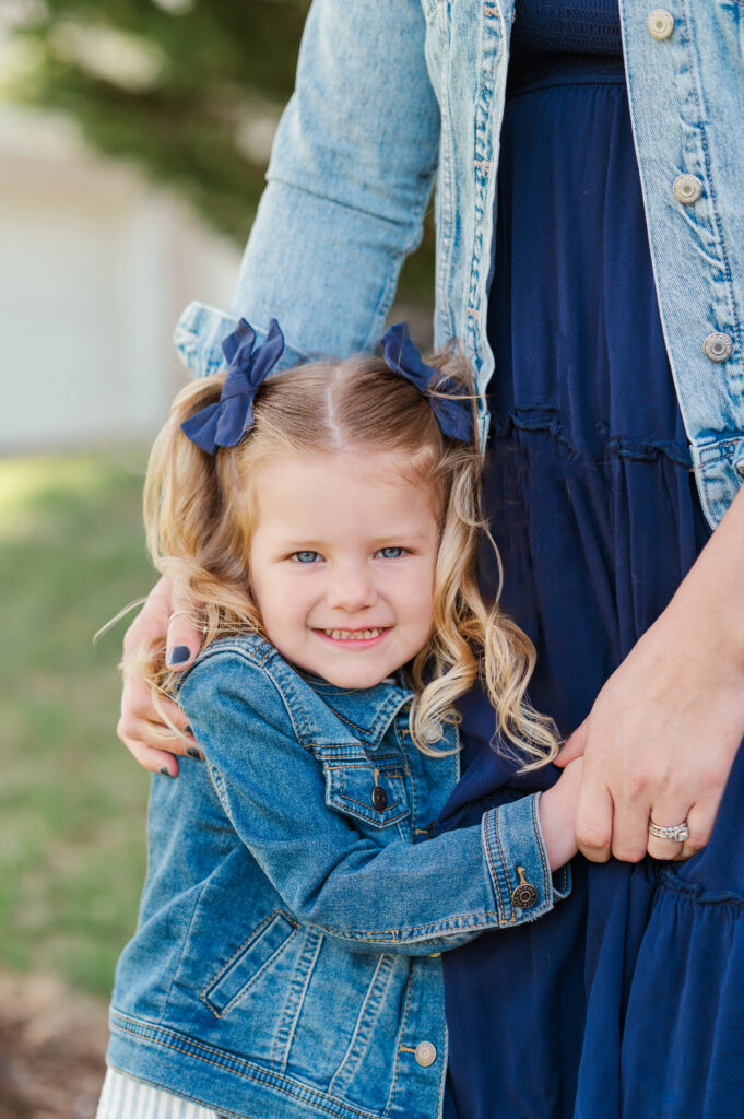 Little girl hugging mom during a spring family photo session in York PA