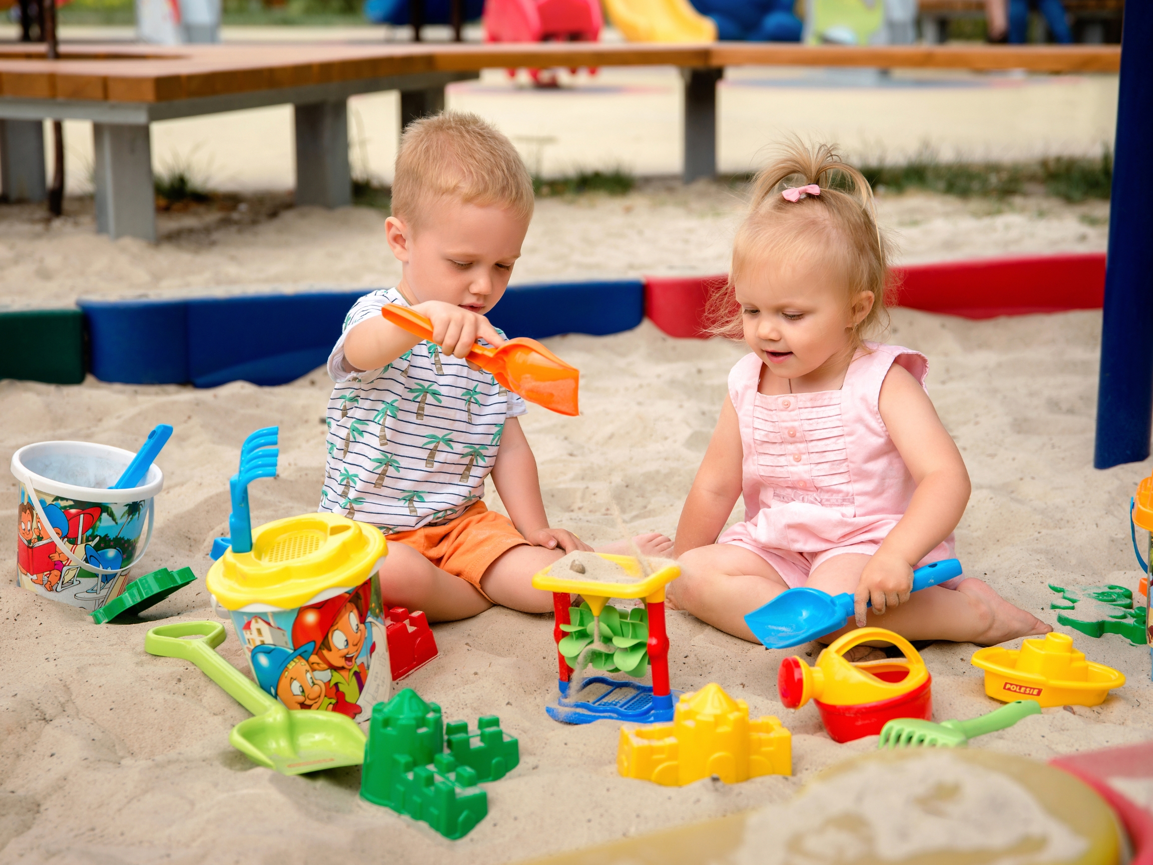 Toddler boy and girl playing in summer sand in Central PA
