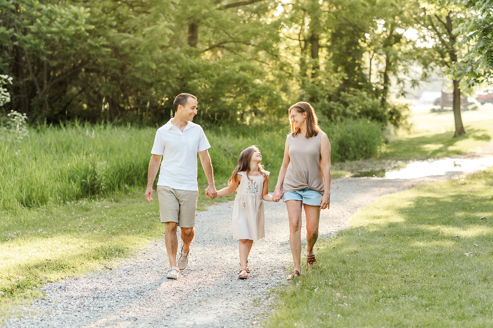 Family walking hand in hand at Mill Creek Preserve in York, PA during summer session