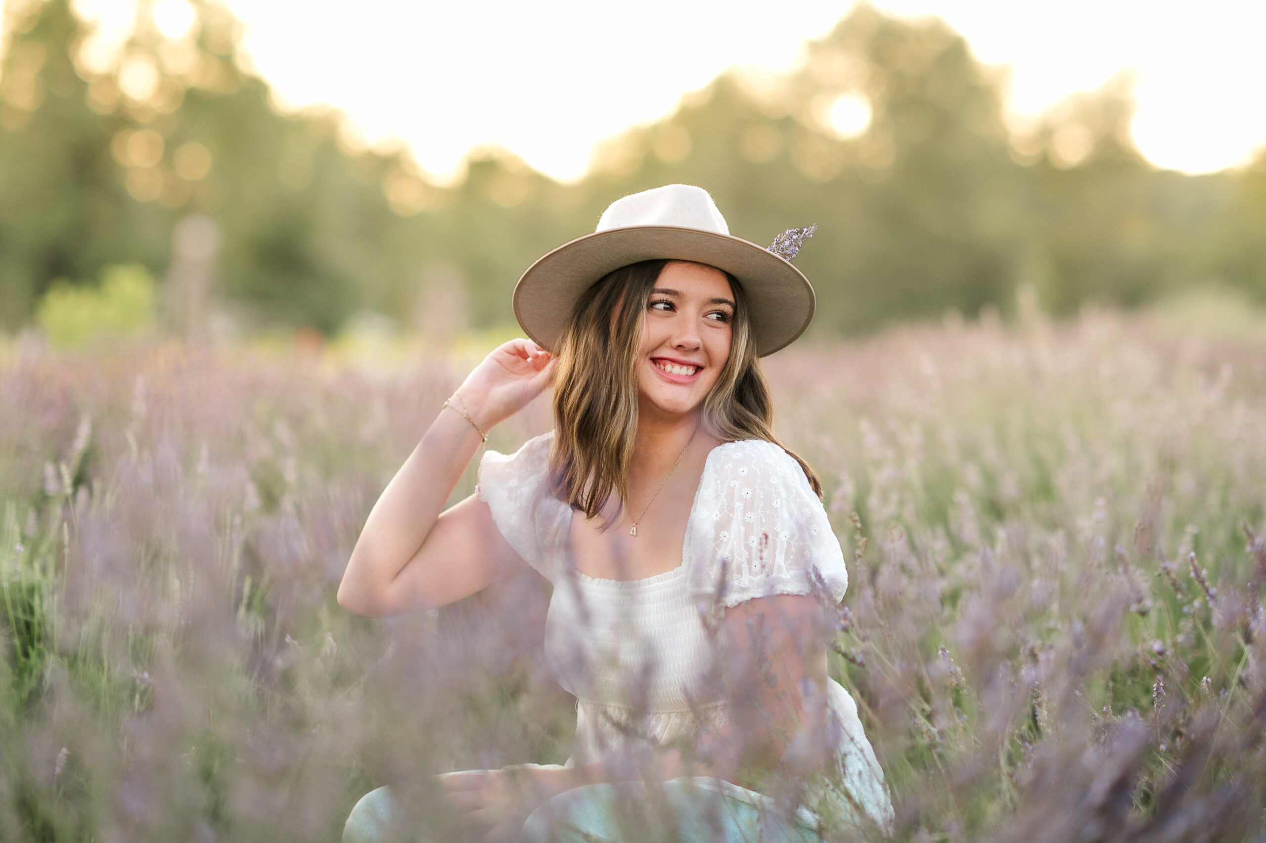 Class of 2026 senior girl in lavender field smiling at golden hour by Lancaster PA photographer Kara Michelle
