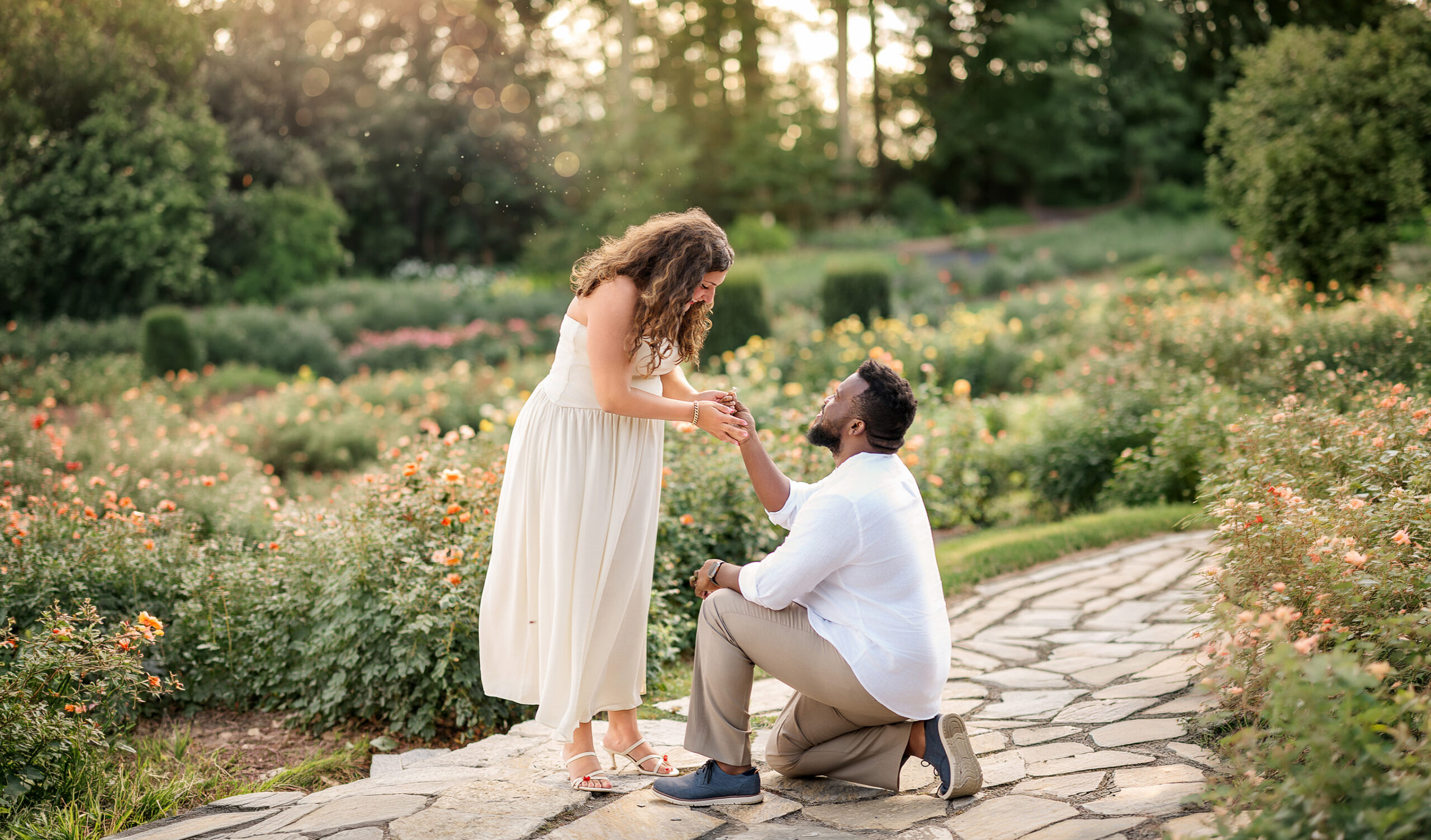 man proposing on one knee with woman smiling during surprise proposal in lancaster pa
