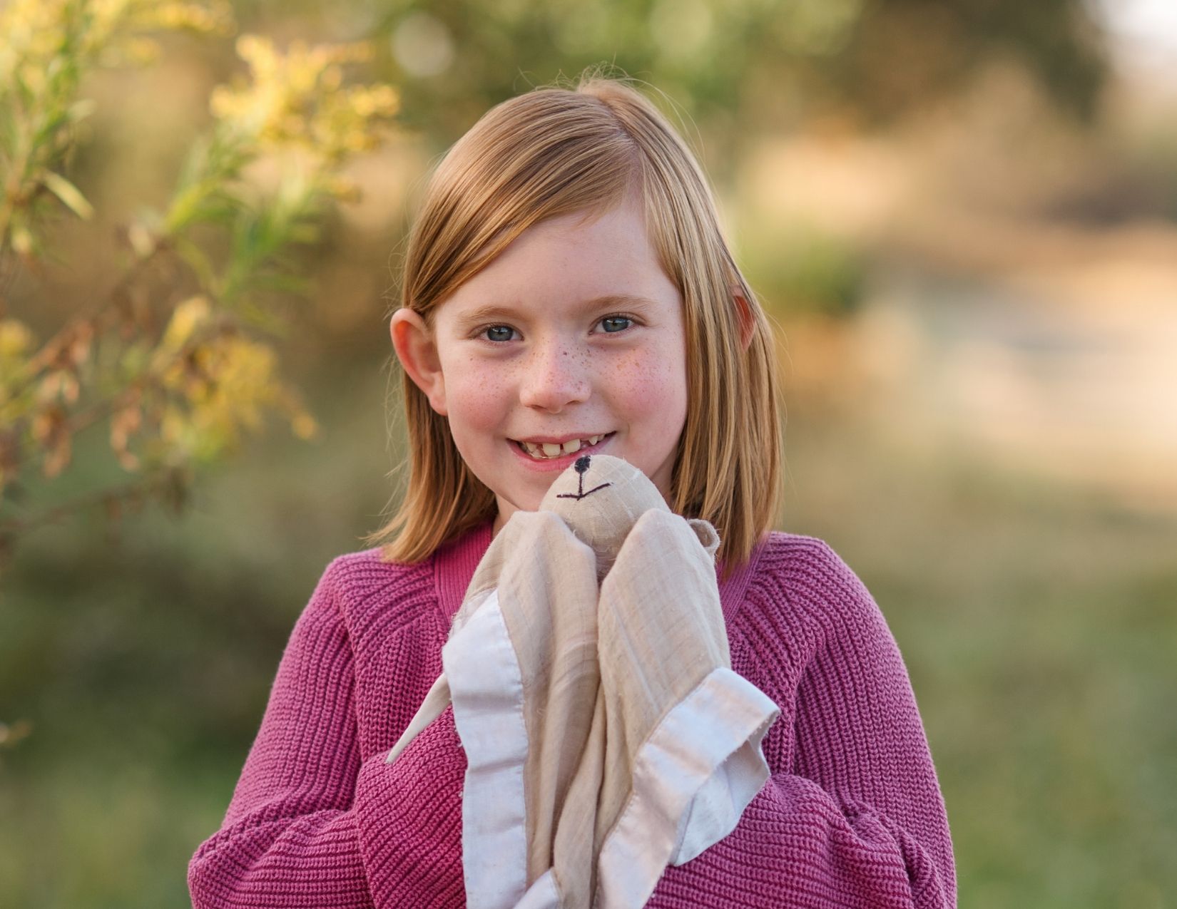 Child holding a lovey during a lifestyle family photography session in York, PA