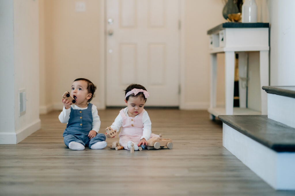 Twin babies sitting together during lifestyle sitter session in Lancaster PA