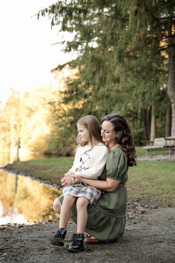 Mother holding her daughter by the lake during a fall mommy and me photography session in Harrisburg, PA