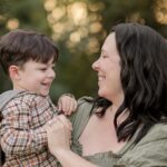 Mother smiling at her young son during a golden hour mommy and me photography session in York, PA