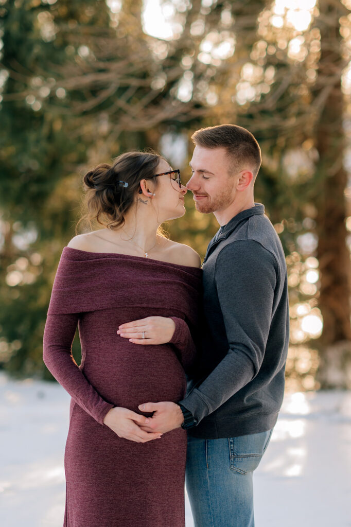 Pregnant woman and partner standing together at sunset maternity session in York PA park.