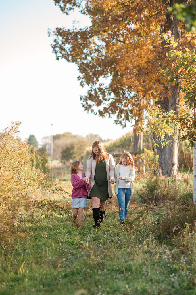 Mom walking with her two children during a fall mommy and me photography session in Lancaster PA