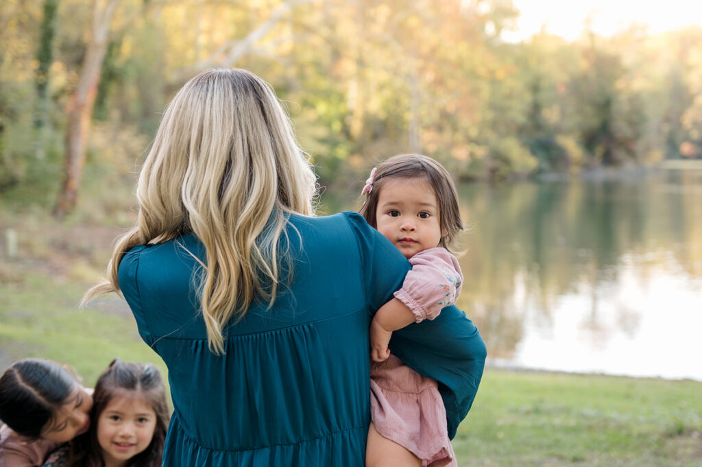 Mom holding her baby during a mommy and me photography session in York PA by the water