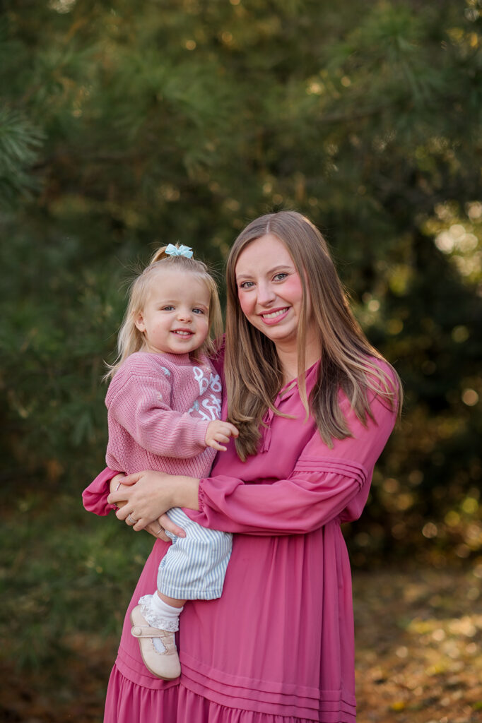 Mom holding her toddler during a mommy and me photography session in York PA, both smiling at the camera