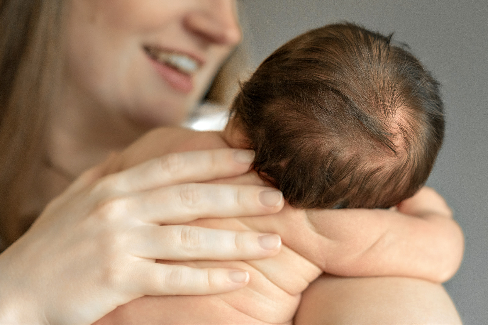mother holding her newborn baby during in-home newborn photography session in York PA