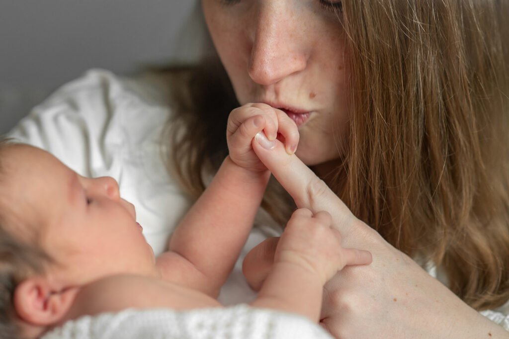 newborn baby snuggled with parents during in home session in York Pennsylvania