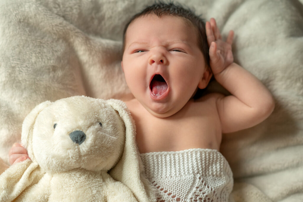 adorable newborn baby yawning during early weeks
