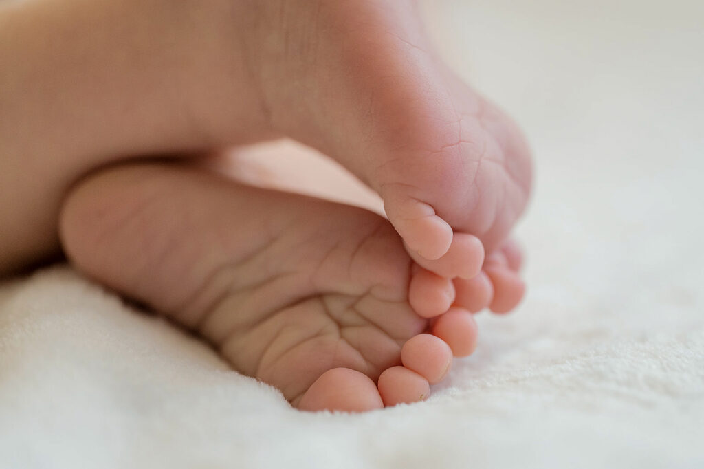 close up of tiny newborn baby feet during first week of life