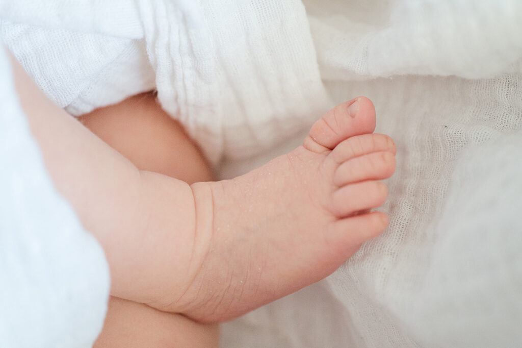 close up of tiny newborn baby feet during first week of life