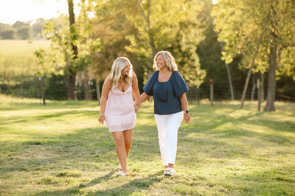 high school senior girl walking with her mom during golden hour outdoor photo session in York PA
