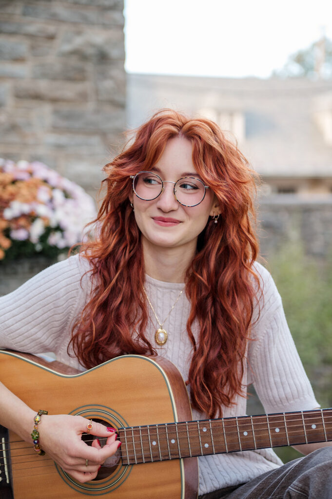 high school senior holding acoustic guitar during outdoor senior portrait session in Lancaster PA