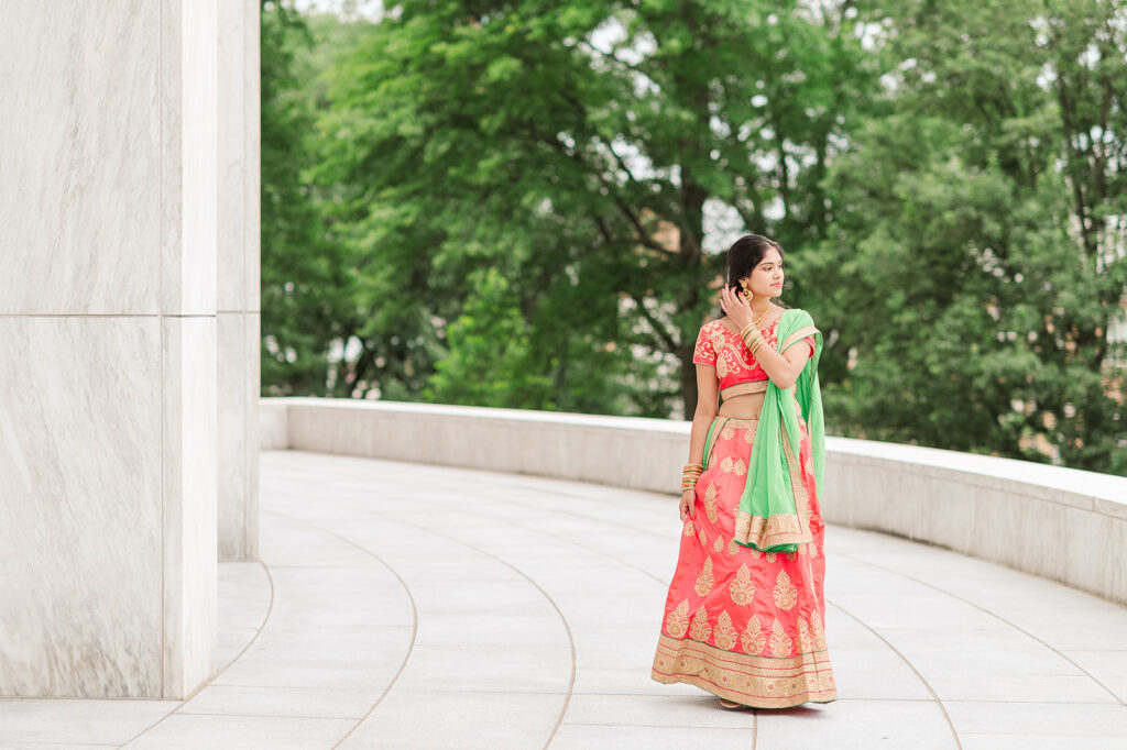 high school senior walking in traditional cultural dress during senior photo session at Pennsylvania State Capitol