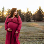 pregnant mom standing in field during golden hour maternity session in York PA
