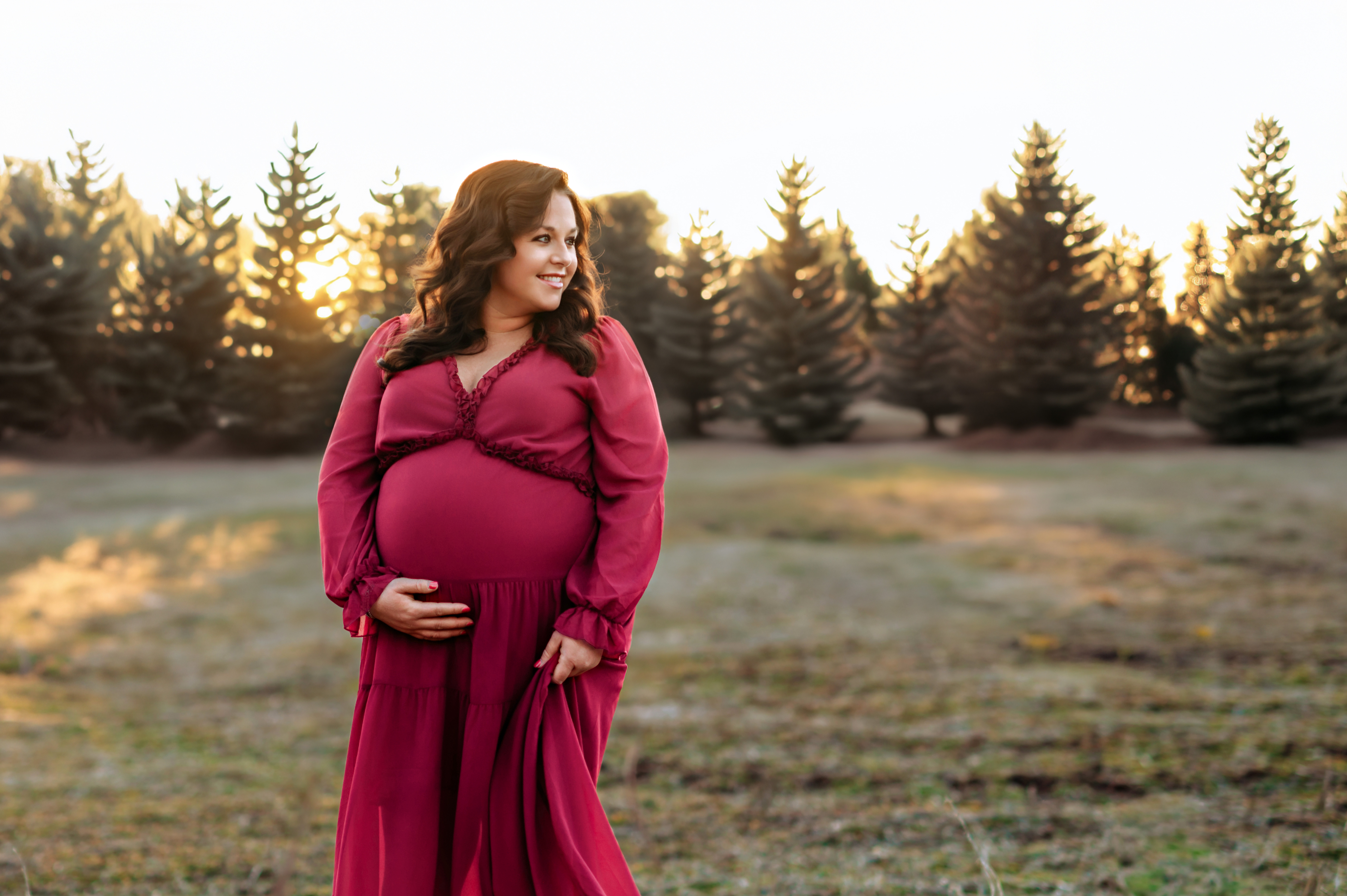 pregnant mom standing in field during golden hour maternity session in York PA