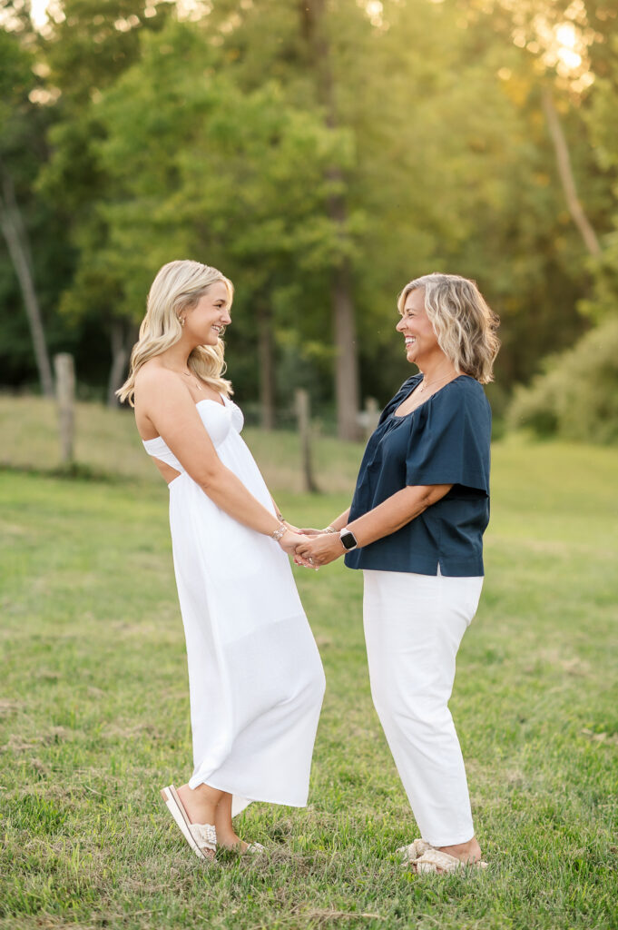 senior and mom holding hands during outdoor photo session
