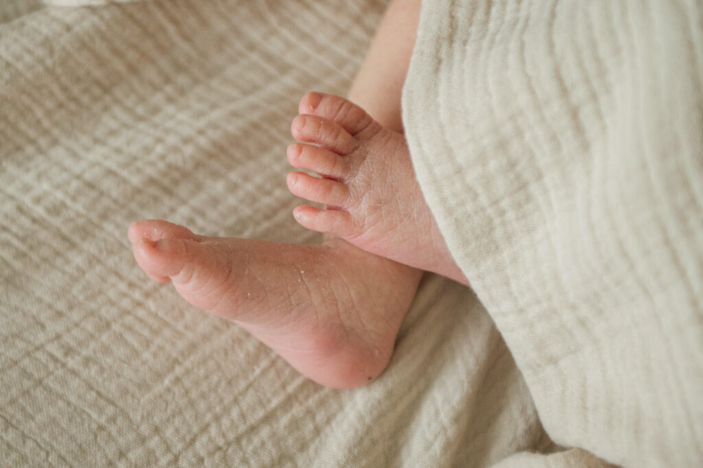 Close-up of a newborn baby’s feet wrapped in a soft blanket during a lifestyle session in York, PA