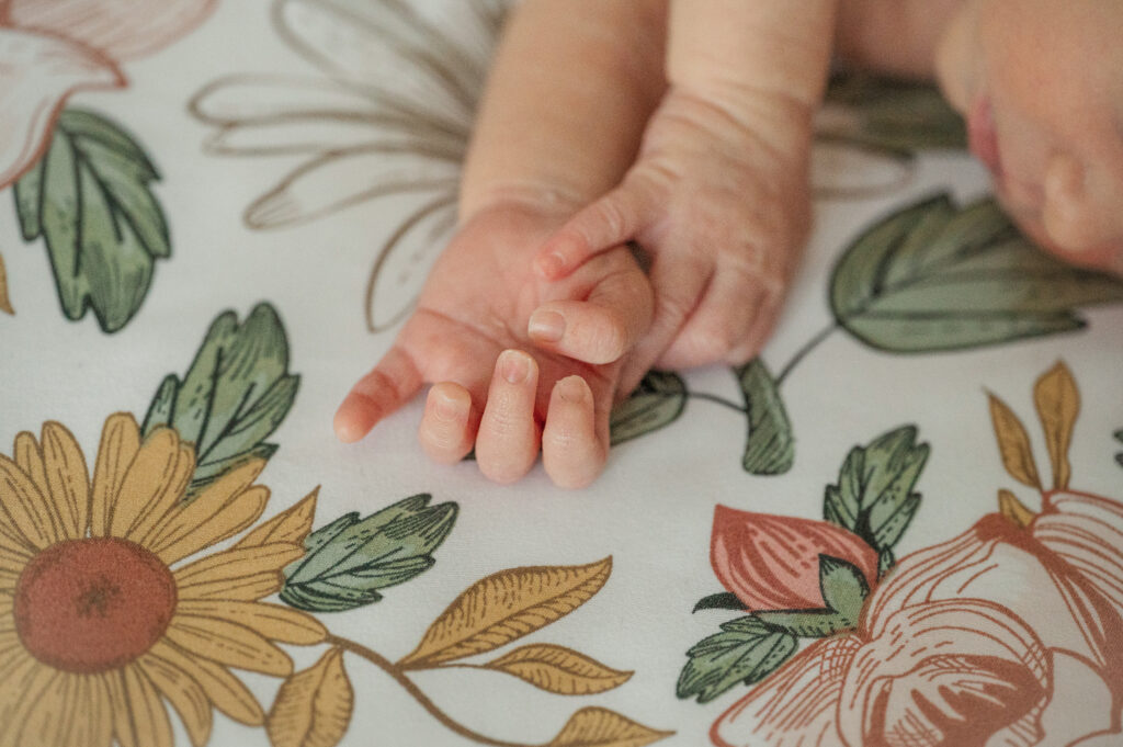 Close-up of a newborn baby’s hands resting on a patterned blanket during a lifestyle session in York, PA