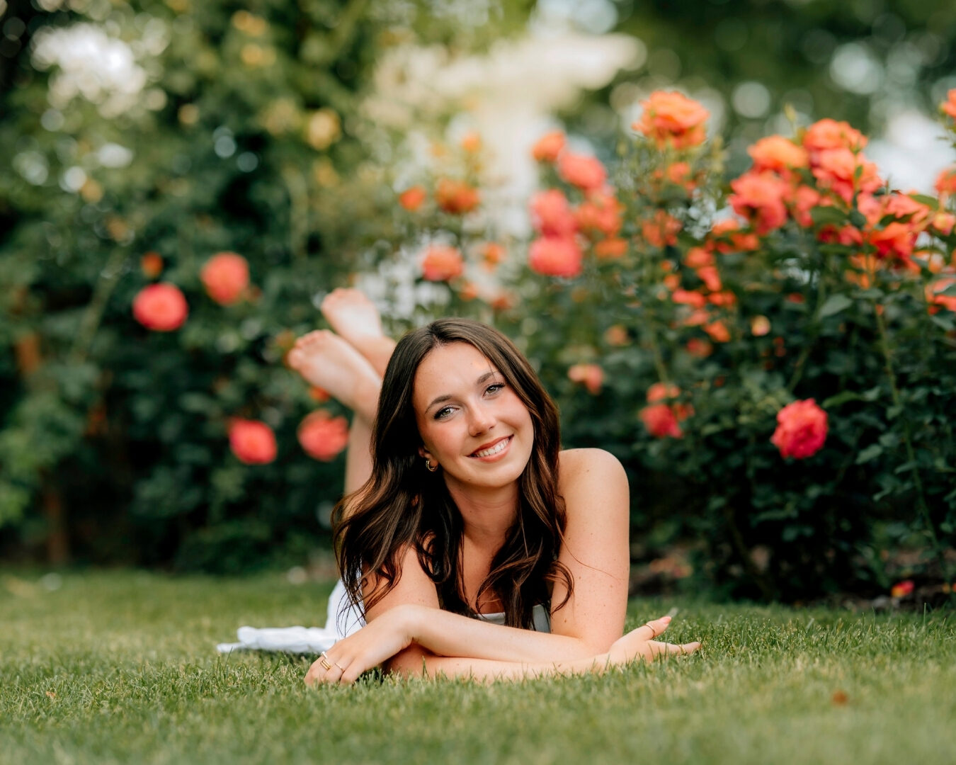 Senior girl laughing in the grass during natural senior pictures in Hershey PA