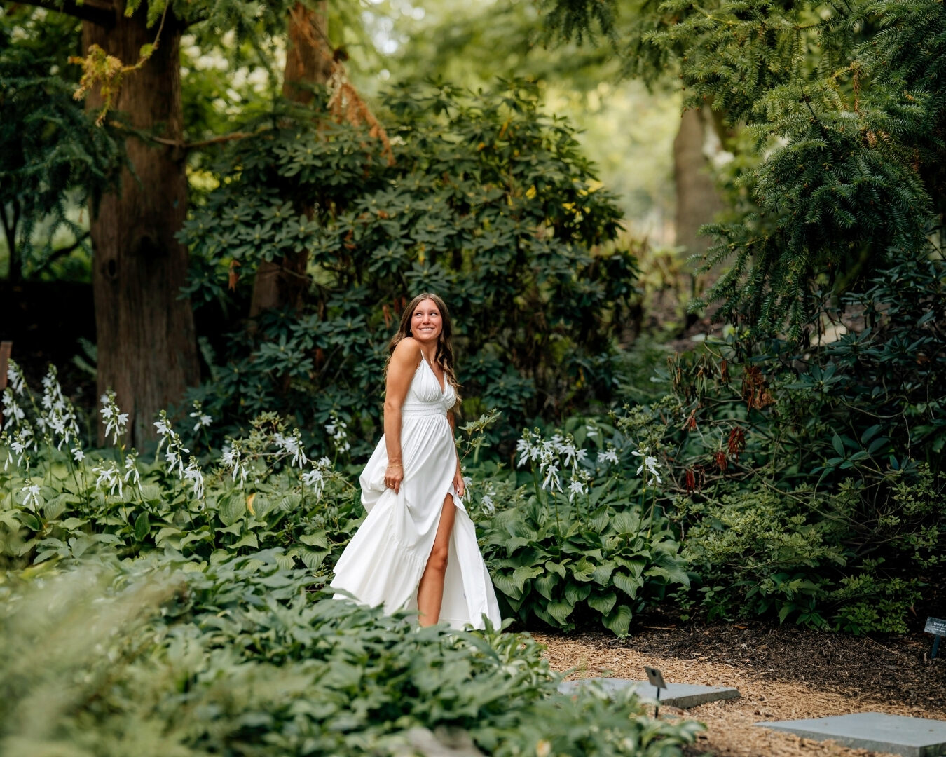 Senior girl laughing naturally in a flowing white dress during senior pictures in York PA