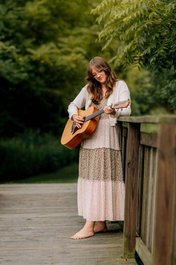 Senior girl with acoustic guitar during senior pictures in Central Pennsylvania