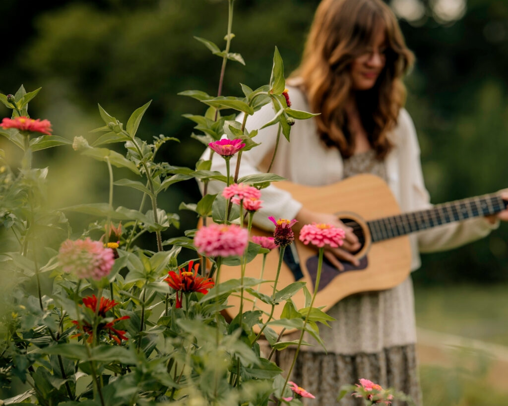 Close-up of high school senior playing acoustic guitar during senior pictures in York PA