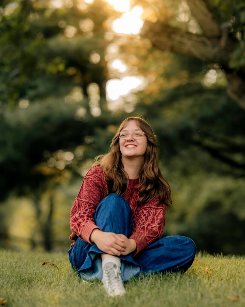 Senior girl sitting in the grass during a casual outdoor senior photography session in York PA